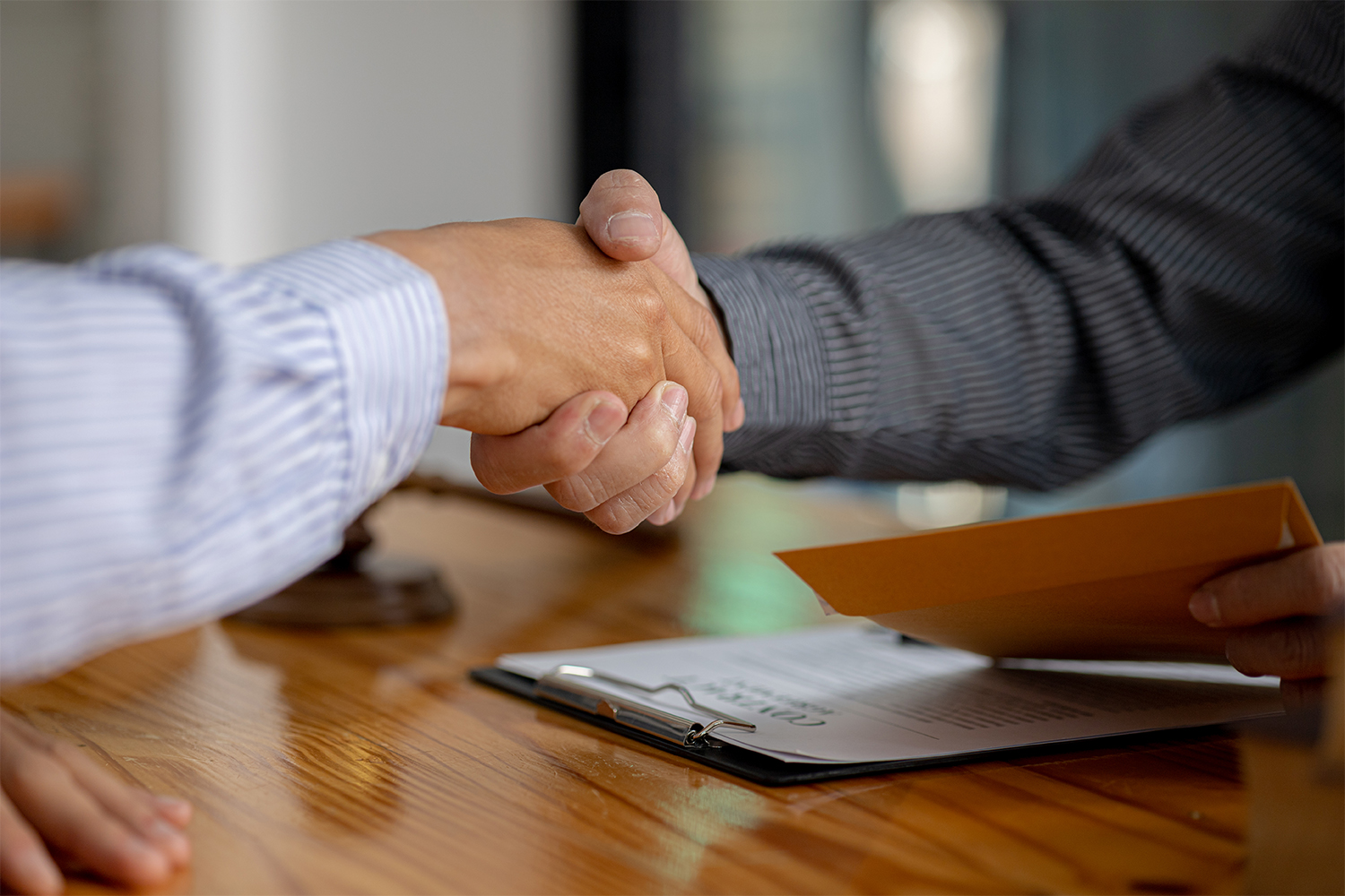 Lawyers shake hands with clients who come to testify in the case